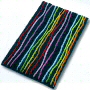 multi color novelty bath rug with fun colored stripes running over a solid background of either black, white or turquoise