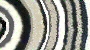 Black round rugs with pearl grey, flannel grey, white, dark grey and black rings
